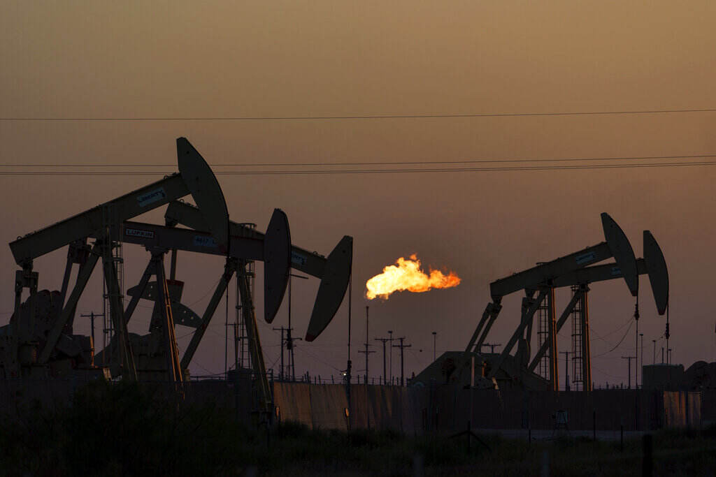 Climate Change-Billowing Methane A flare burns off methane and other hydrocarbons as oil pumpjacks operate in the Permian Basin in Midland, Texas, Tuesday, Oct. 12, 2021. Massive amounts of methane are venting into the atmosphere from oil and gas operations across the Permian Basin, new aerial surveys show. The emission endanger U.S. targets for curbing climate change. (AP Photo/David Goldman)