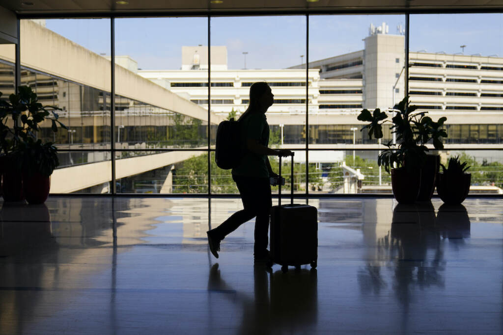 NerdWallet-Millennial-Money-Holiday-Family-Visits A traveler moves through the Philadelphia International Airport