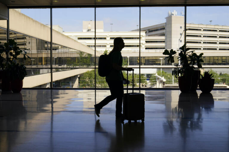A traveler moves through the Philadelphia International Airport