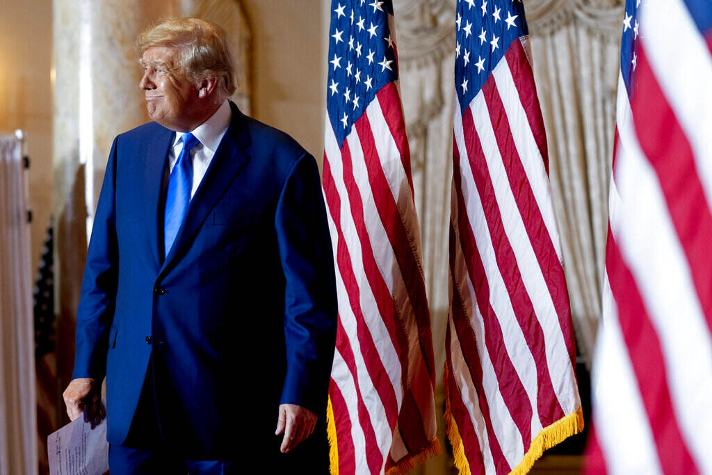 Donald Trump Donald Trump stands next to several U.S. flags.