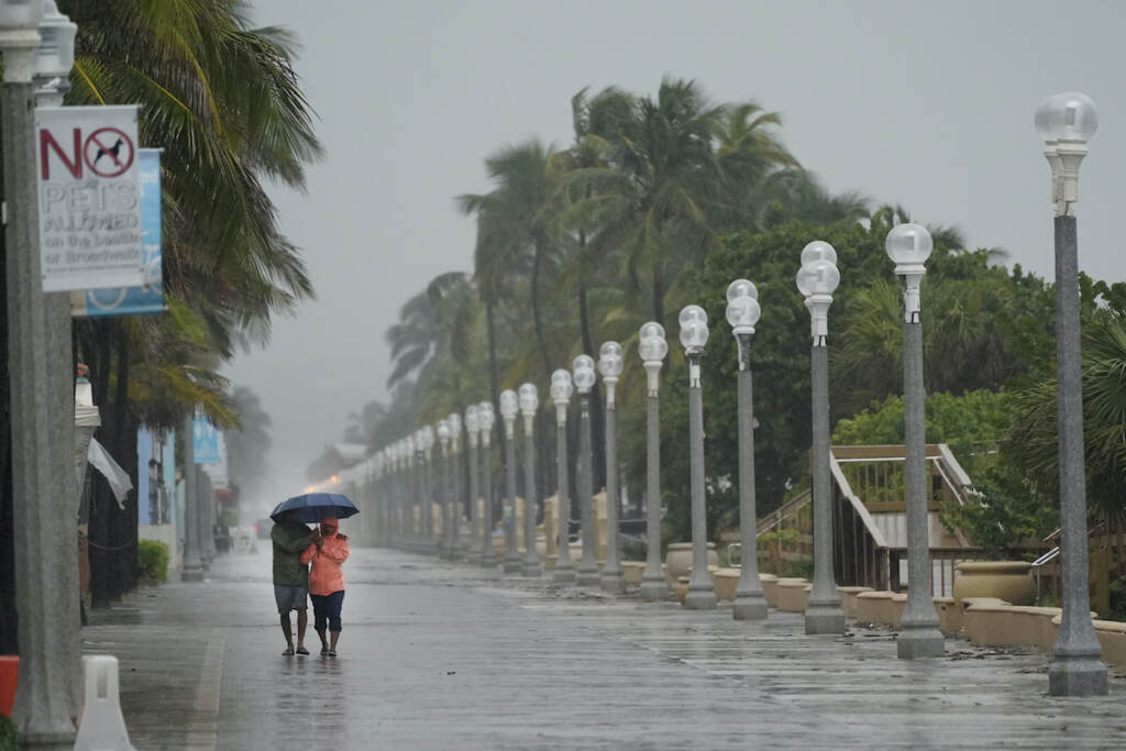 Tropical Weather A pair of beach goers walk on the Hollywood Beach Broadwalk as conditions deteriorate with the approach of Hurricane Nicole, Wednesday, Nov. 9, 2022, in Hollywood Beach in Hollywood, Fla. (AP Photo/Wilfredo Lee)