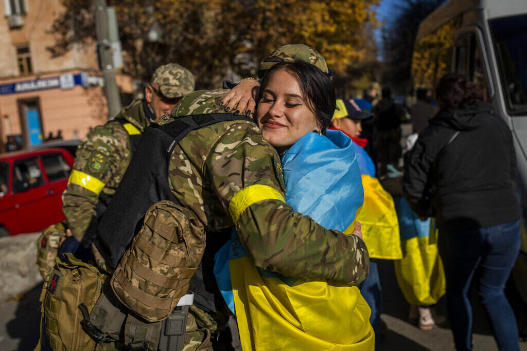 APTOPIX Russia Ukraine War A Kherson resident hugs a Ukrainian defence force member in Kherson, southern Ukraine, Monday, Nov. 14, 2022. The retaking of Kherson was one of Ukraine's biggest successes in the nearly nine months since Moscow's invasion. (AP Photo/Bernat Armangue)