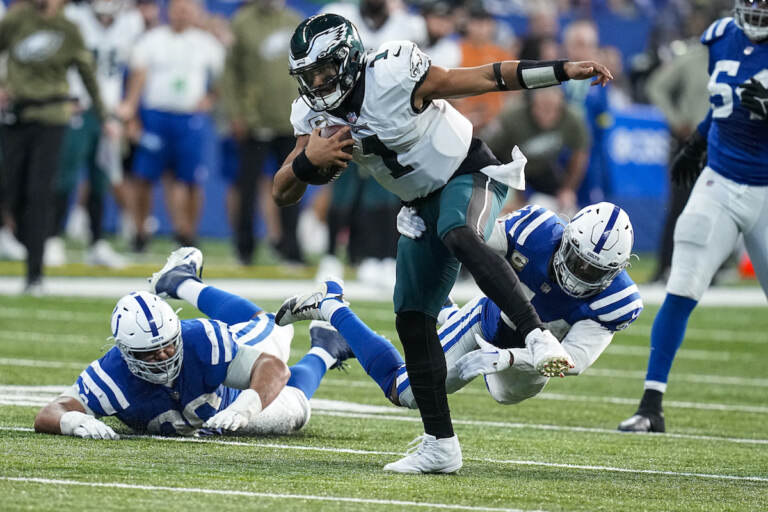 Philadelphia Eagles quarterback Jalen Hurts (1) is pursued by Indianapolis Colts linebacker Zaire Franklin (44) in the second half of an NFL football game in Indianapolis, Fla., Sunday, Nov. 20, 2022. (AP Photo/Darron Cummings)