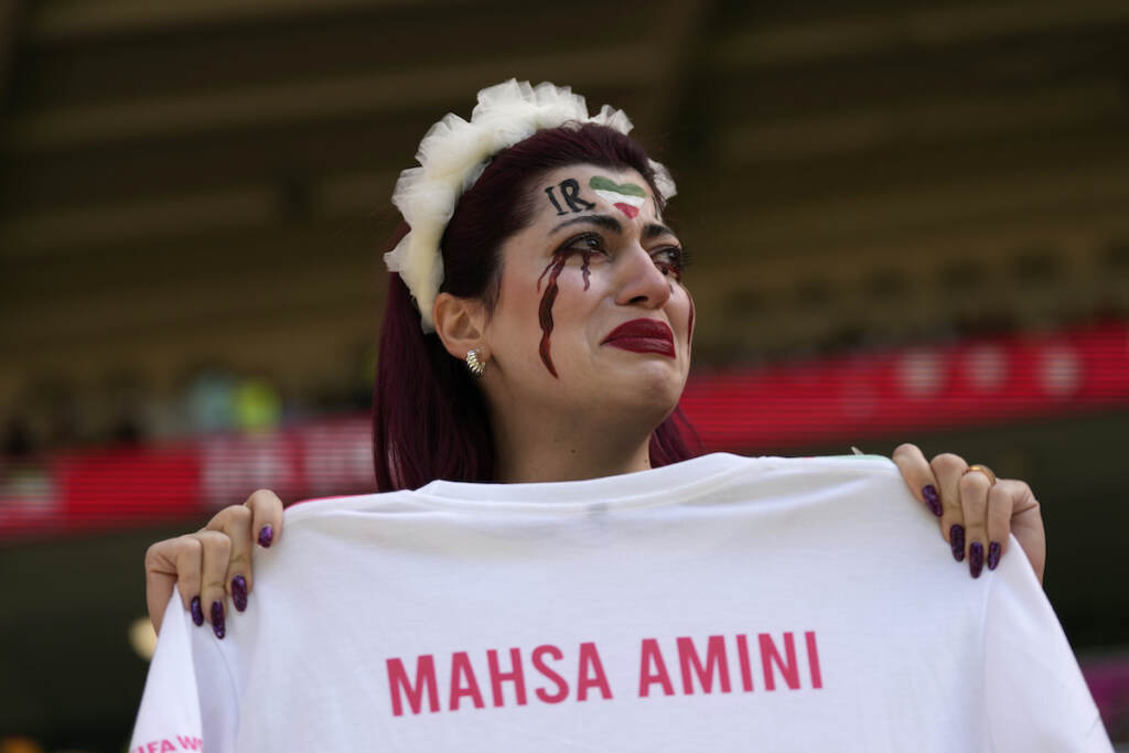 APTOPIX WCup Wales Iran Soccer An Iran team supporter cries as she holds a shirt that reads ''Mahsa Amini'' prior to the start of the World Cup group B soccer match between Wales and Iran, at the Ahmad Bin Ali Stadium in Al Rayyan, Qatar, Friday, Nov. 25, 2022. (AP Photo/Alessandra Tarantino)