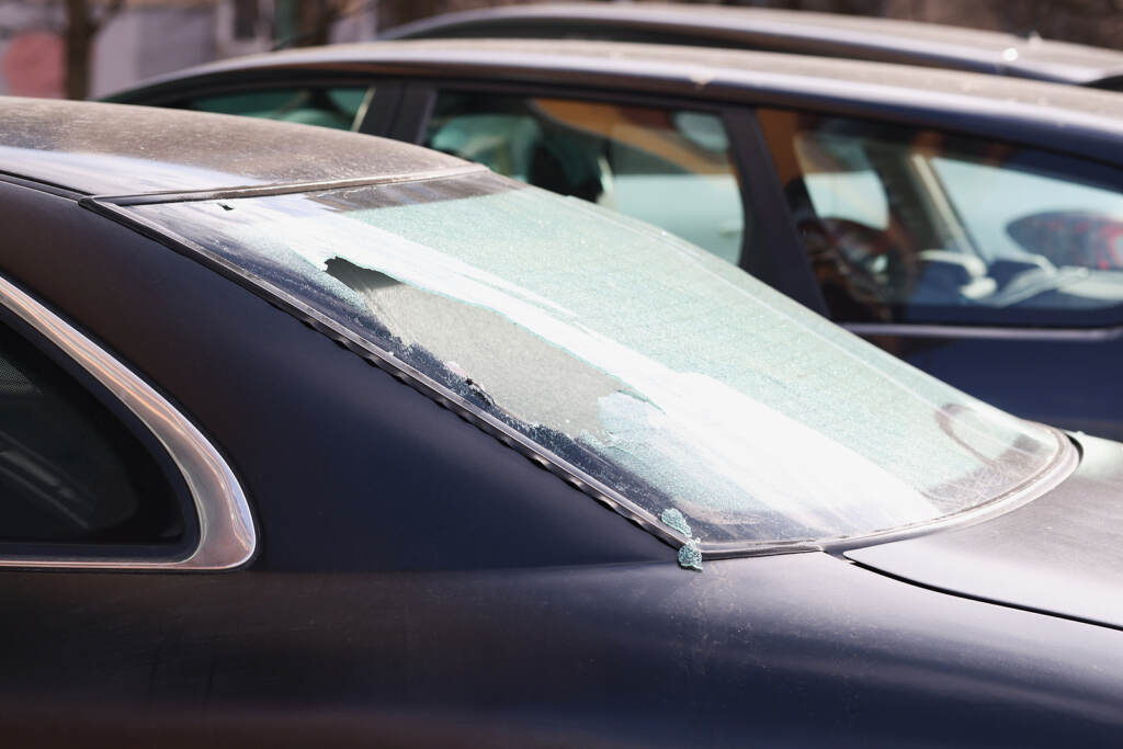 Broken Rear Window Of A Car On The Street, Close-up. Criminal Di (HannaKuprevich/BigStock)