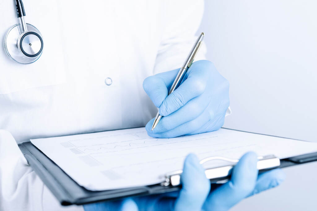Clipboard Medical Background. Happy Nurse In Blue Gloves, Clipboard Hospital Wearing Scrubs, Provide A medical person holds a clipboard in their hands.