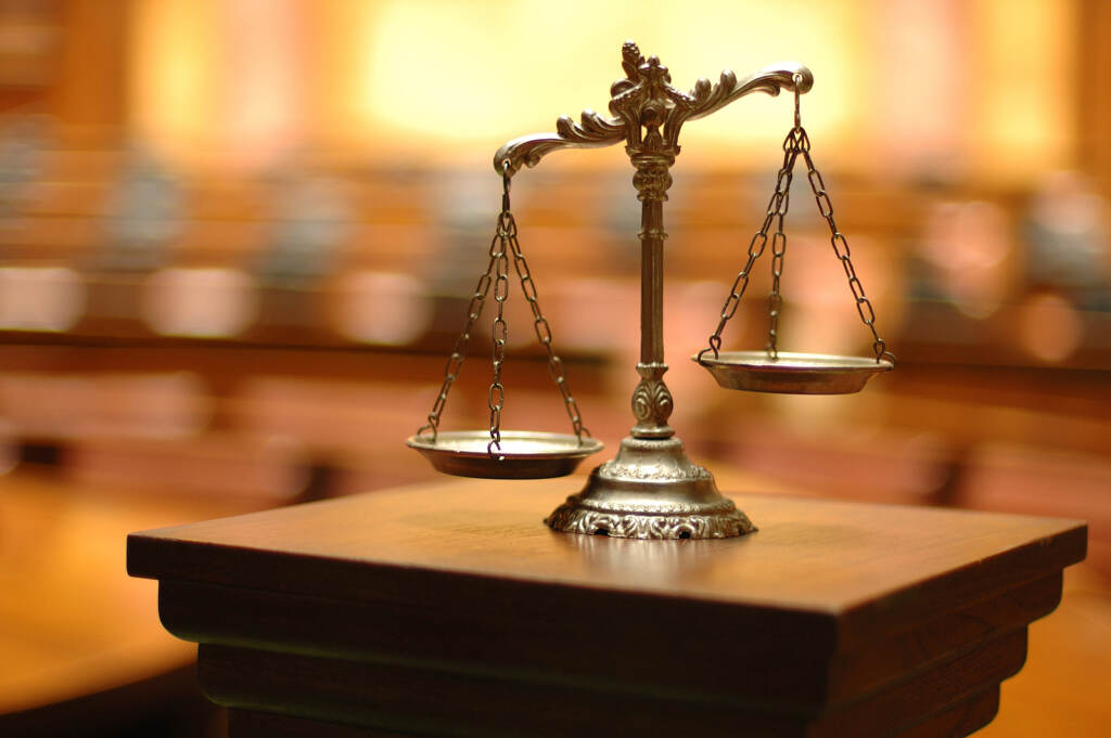 Symbol Of Law And Justice In The Empty Courtroom, Law And Justic A scale is seen as a symbol of law and justice