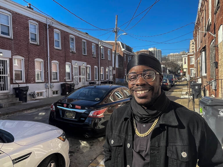 Davian Green smiles for a photo on an East Side sidewalk