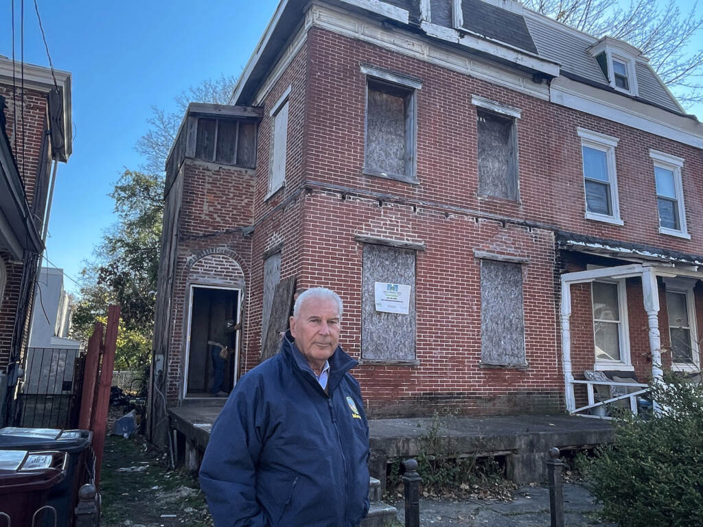Mayor Mike Purzycki stands outside a long-abandoned home now being renovated.
