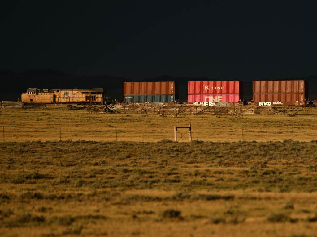 A Union Pacific freight train carries cargo along a rail line at sunset in Bosler, Wyoming, on August 13, 2022. (Patrick T. Fallon/AFP via Getty Images)