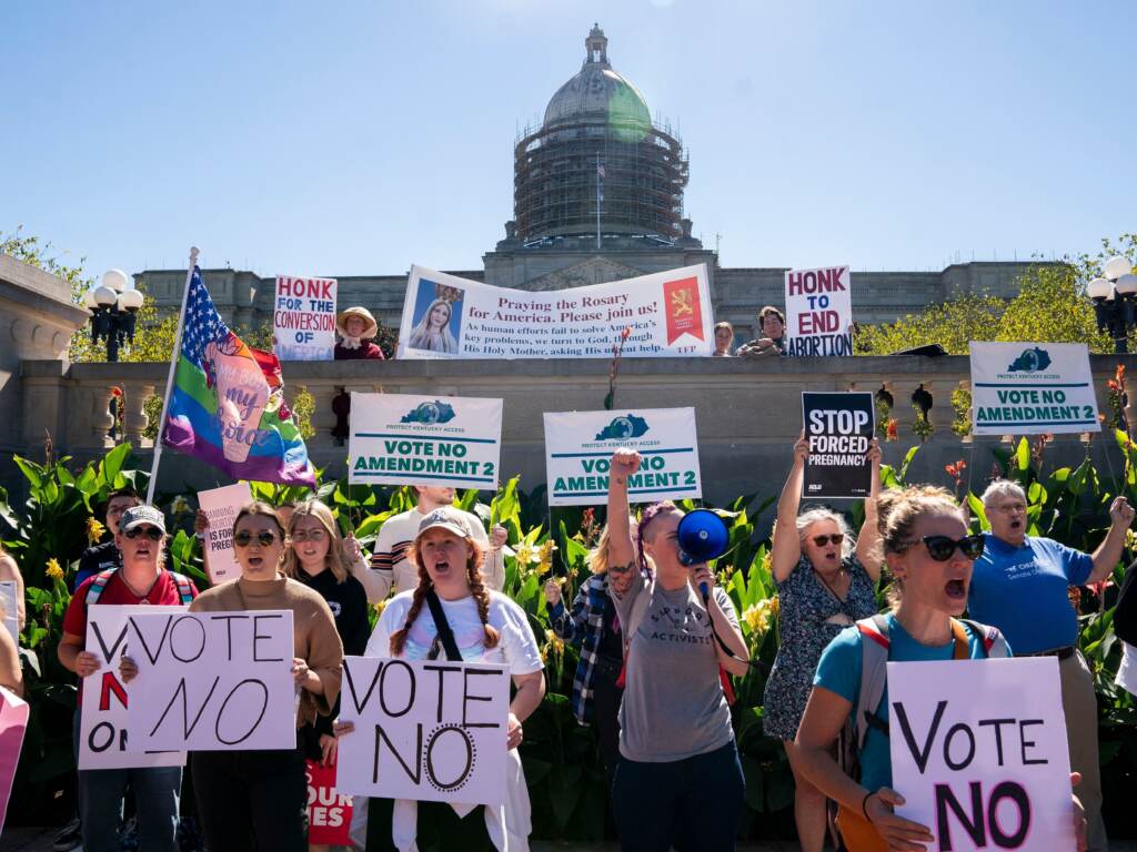Kentucky voters have rejected an amendment that would have said the state constitution contains no right to an abortion. Earlier, people rallied on the steps of the Kentucky State Capitol in Frankfort to encourage voters to vote yes on Amendment 2, which failed. People stand with signs that read