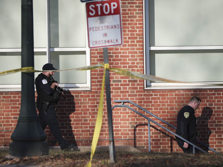 Law enforcement personnel move through the crime scene. (Win McNamee/Getty Images)