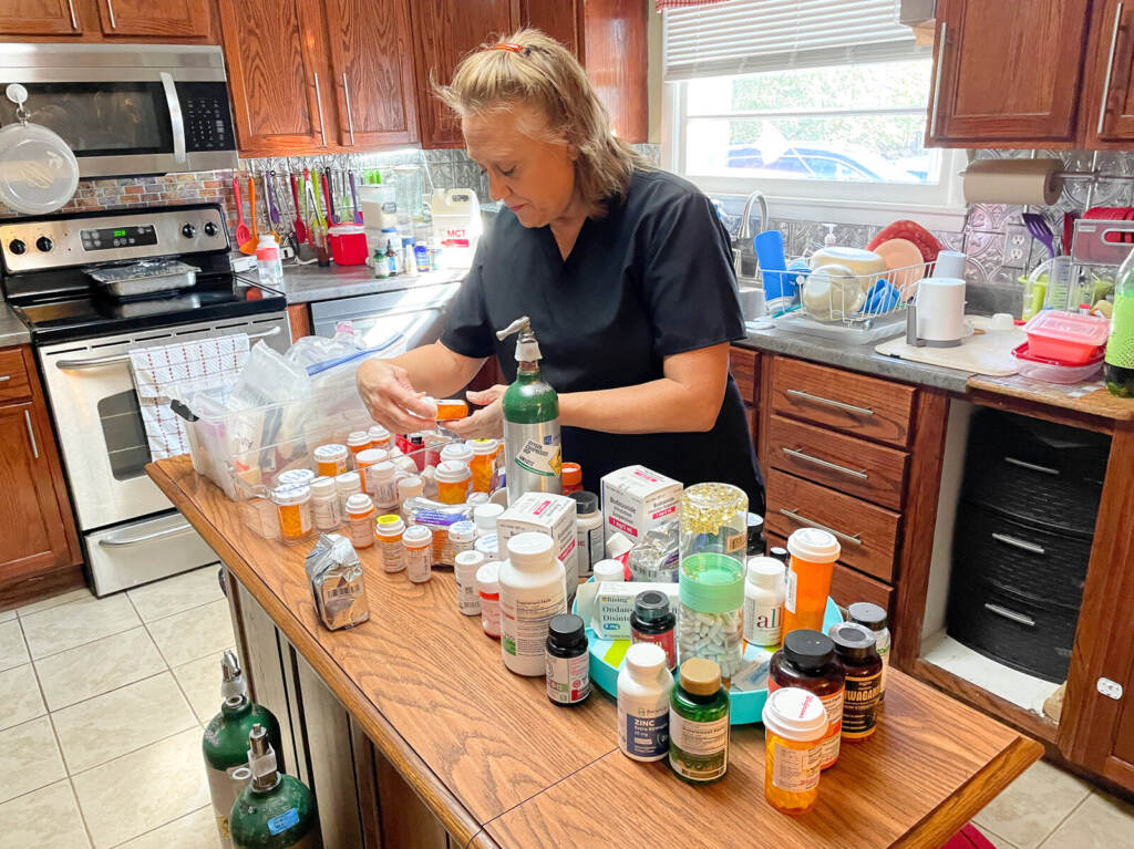 longcovid22-1-2npr Cinde Lucas, whose husband Rick has suffered from long COVID, examines the many supplements and prescription medications he tried while looking for something to combat brain fog, depression and fatigue. (Blake Farmer/ WPLN)