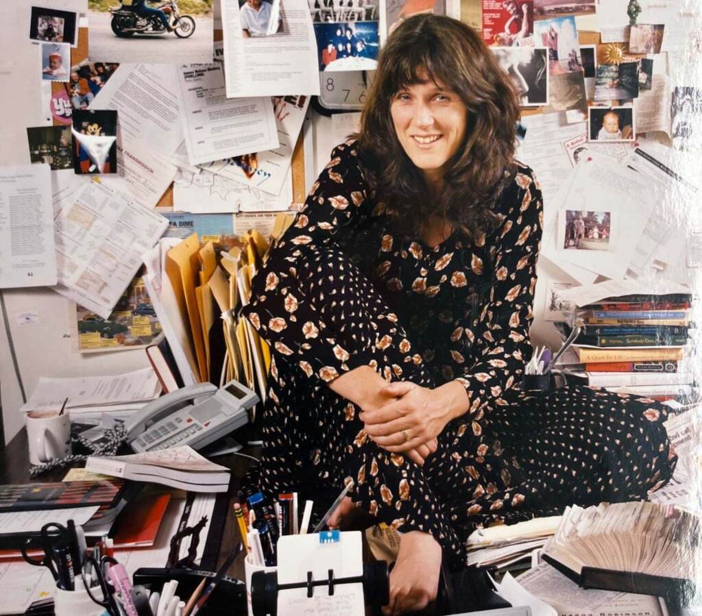 marty-moss-coane-desk Marty Moss-Coane is seen sitting on a desk in her office