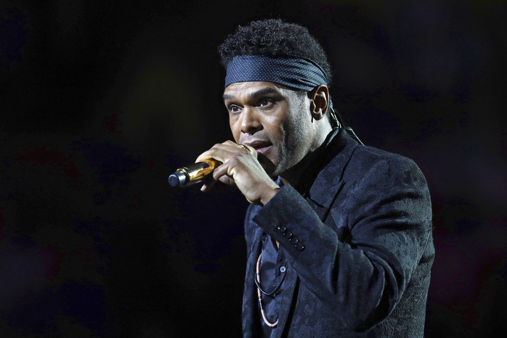 A man sings into a microphone.