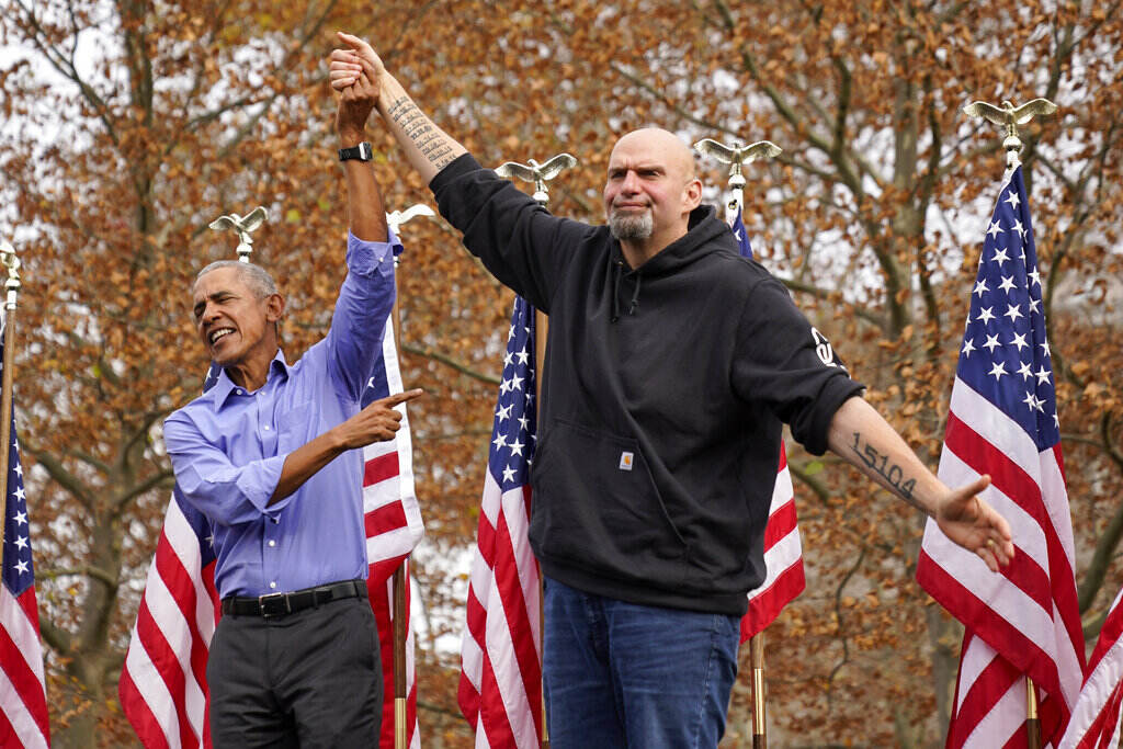 Former President Barrack Obama, left, finishes his remarks and welcomes Pennsylvania Lt. Gov. John Fetterman, a Democratic candidate for U.S. Senate, to the stage during a campaign rally in Pittsburgh, Saturday, Nov. 5, 2022.