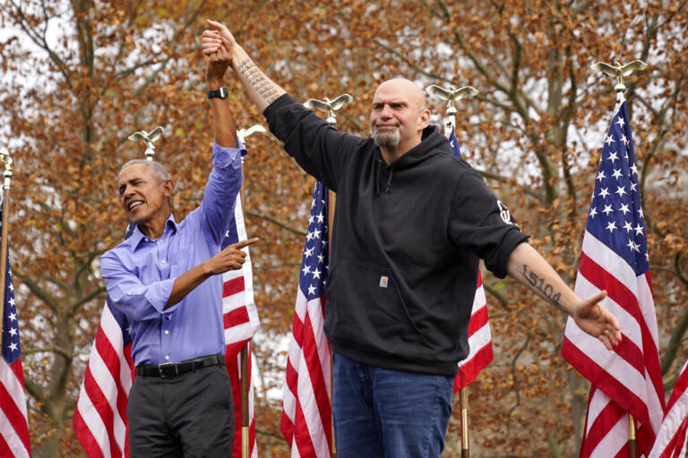 Former President Barrack Obama, left, finishes his remarks and welcomes Pennsylvania Lt. Gov. John Fetterman, a Democratic candidate for U.S. Senate, to the stage during a campaign rally in Pittsburgh, Saturday, Nov. 5, 2022.