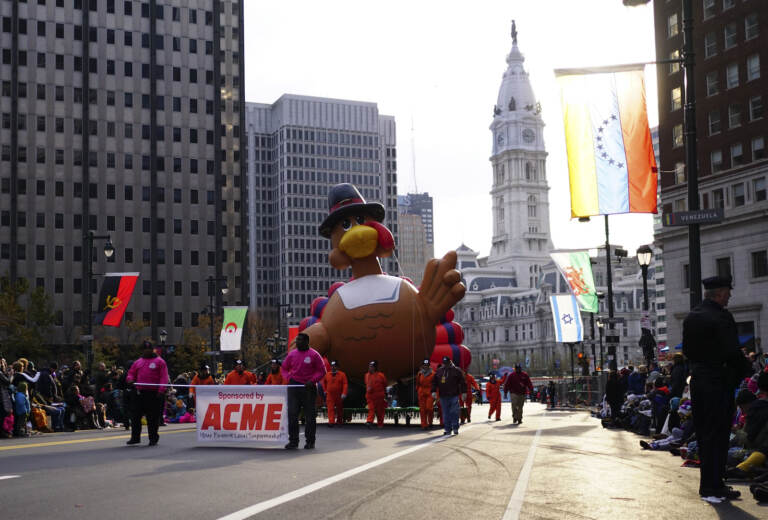 Handlers walk The Turkey balloon down the Benjamin Franklin Parkway