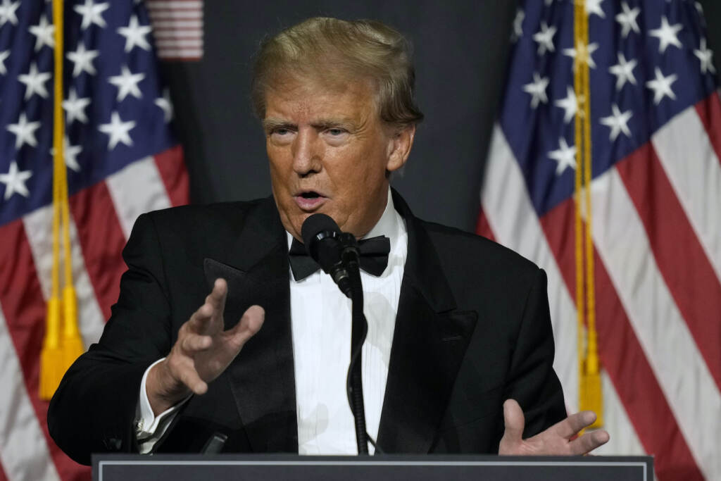 Trump Taxes A closeup of Donald Trump in front of American flags