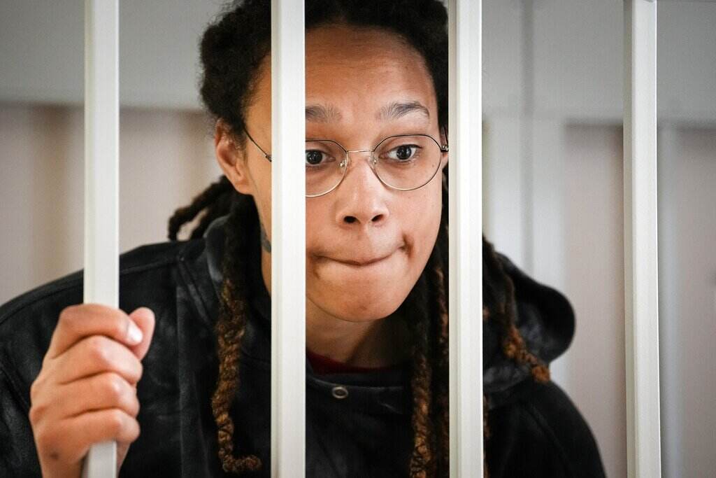 Brittney Griner Brittney Griner stares through the bars of a cell.