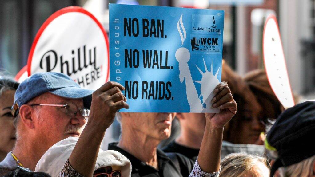 sanctuarycity-protest-immigrant-sign-1024×576 Protesters in Old City in 2017 march against building a border ''wall.'' (Angela Gervasi/Billy Penn)