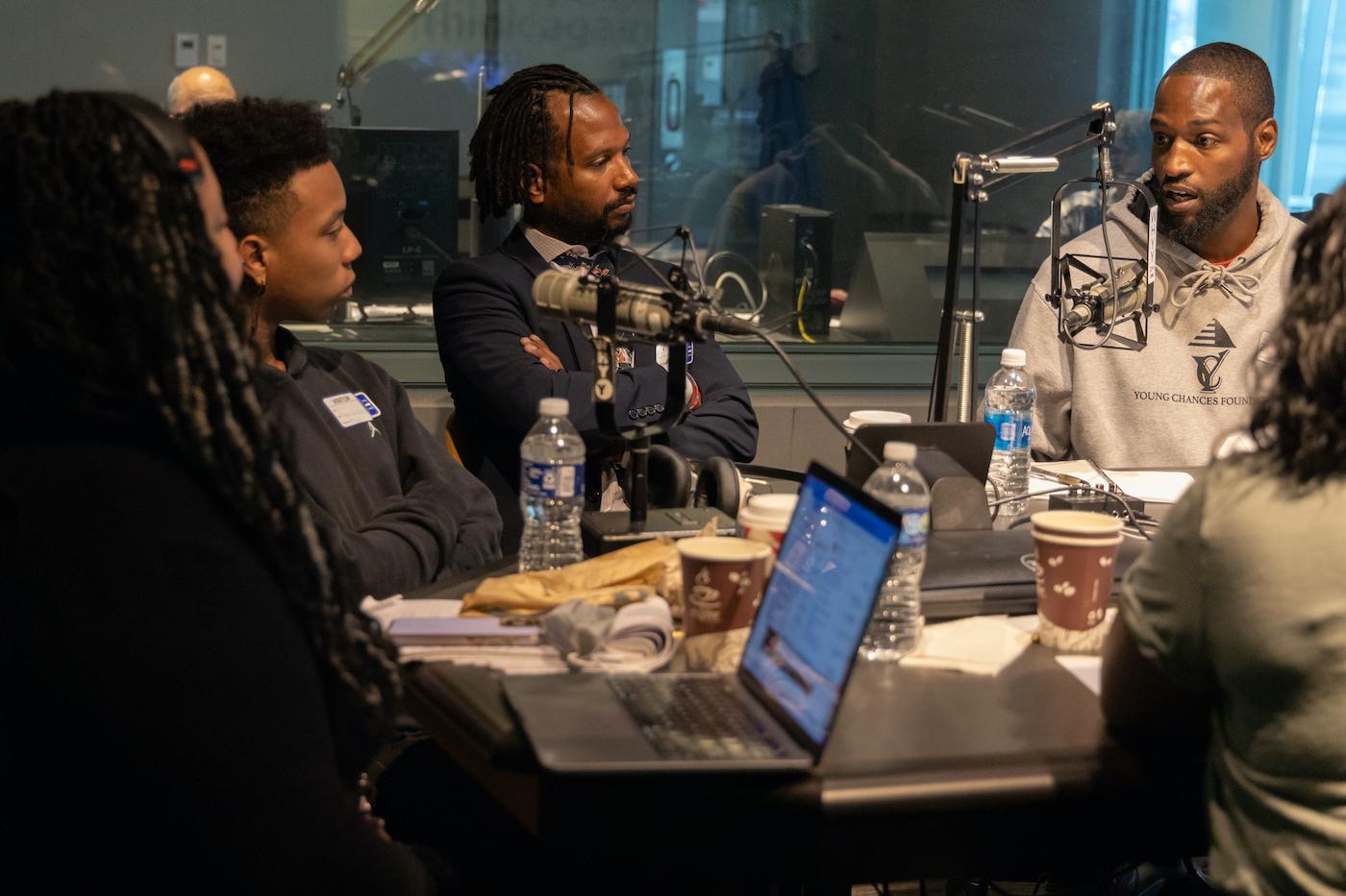 11 11 2022 k paynter stop and frisk podcast recording 11-11-22-18 A group of people speak into microphones at a roundtable discussion.