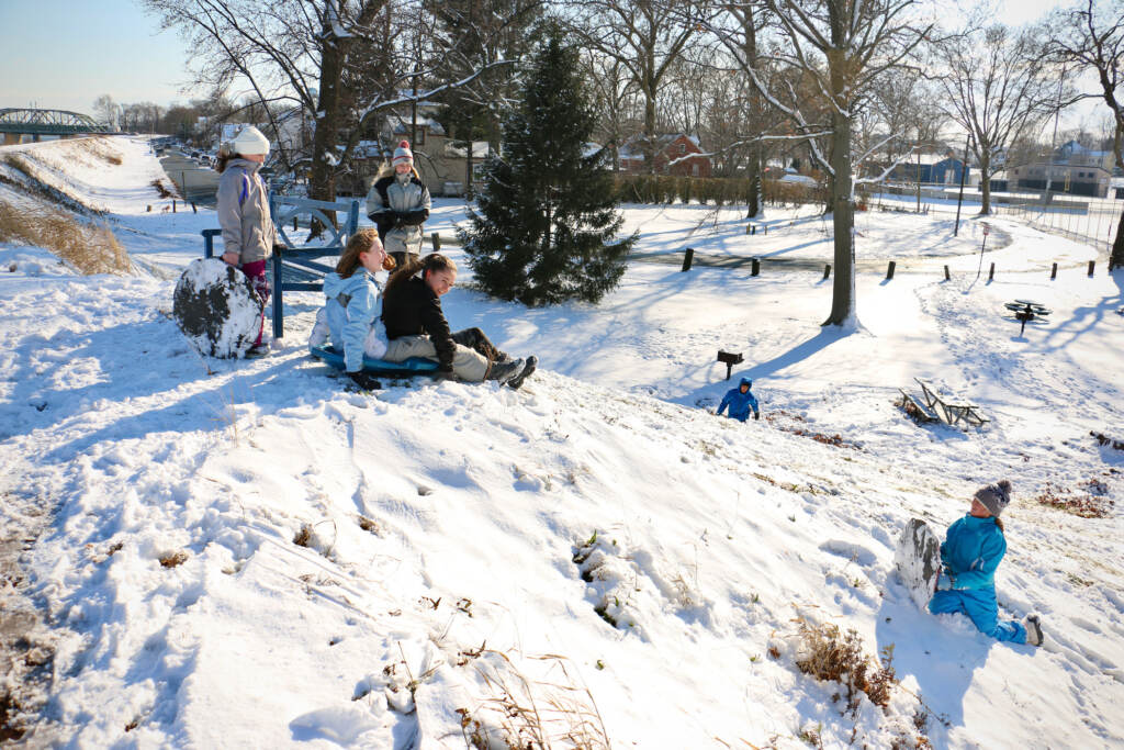 2022 01 07-e lee-morrisville pa-saving williamson park levee Children sled down the levee that separates Williamson Park from the Delaware River in Morrisville