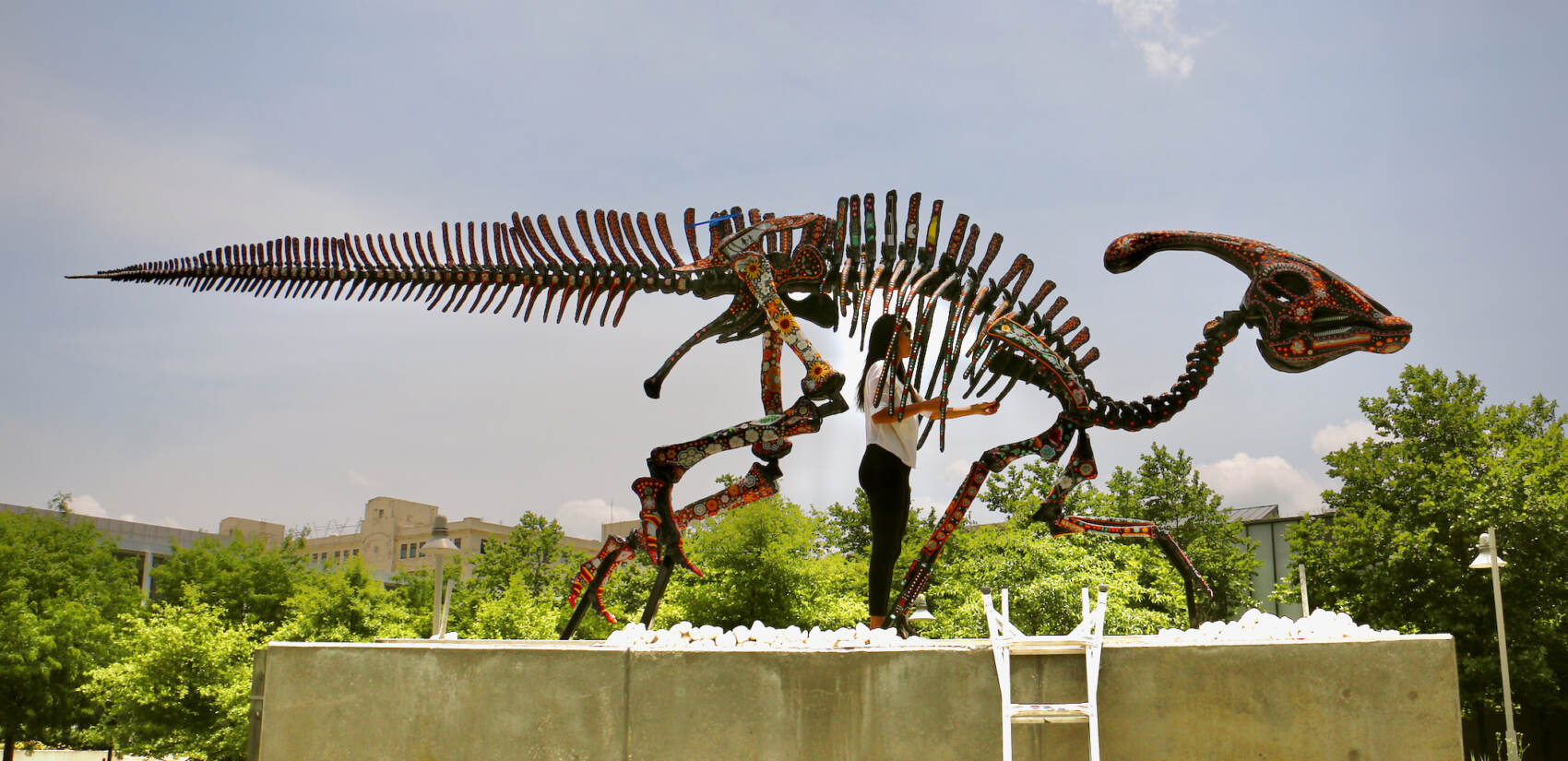 Artist Marianela Fuentes stands in the ribcage of her sculpture, ''Alpha Sacred Beings (The Order of Creation),'' mounted on a six foot concrete plinth in Philadelphia Navy Yard.