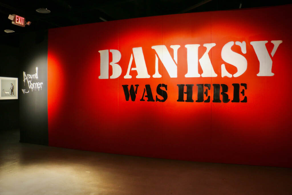 2022 11 30-e lee-philadelphia fashion district-banksy was here exhibit sign ''Banksy Was Here'' occupies a two-story, 30,000-square-foot gallery in the Fashion District mall. (Emma Lee/WHYY)