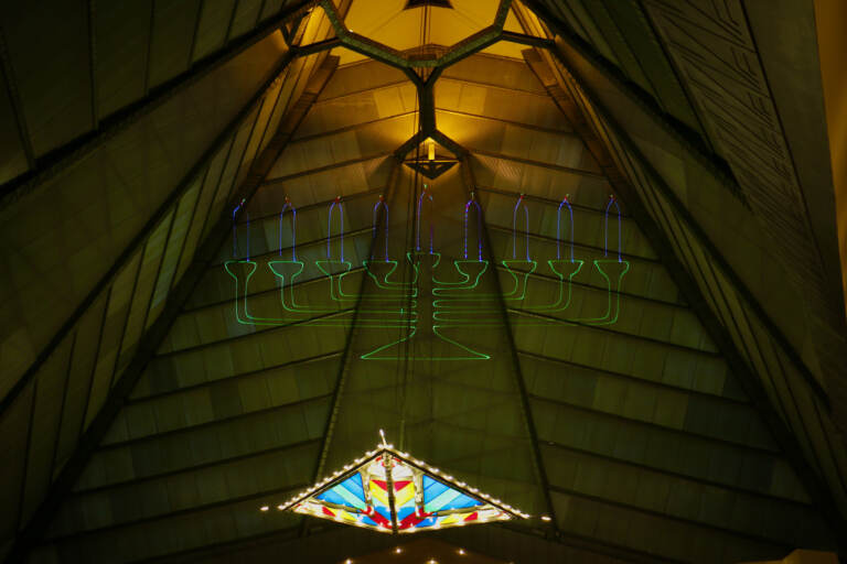 A laser-light menorah is projected into the 110-foot dome of the Beth Sholom Synagogue in Elkins Park. The synagogue will celebrate the holidays with a Hanukkah themed light show. (Emma Lee/WHYY)