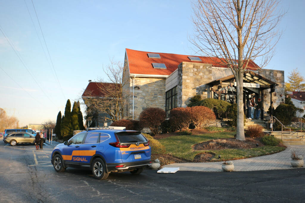 A security car is parked outside of a building.