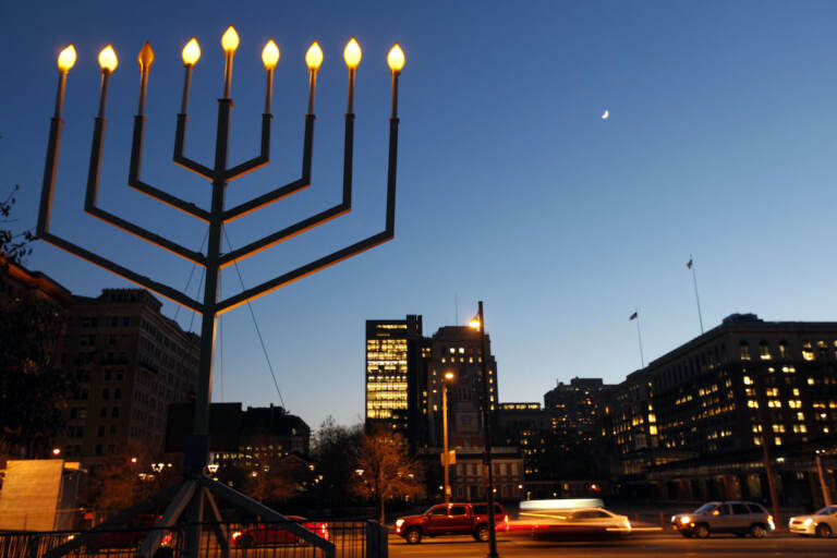 A large menorah is seen in the foreground. In the background is Independence Mall