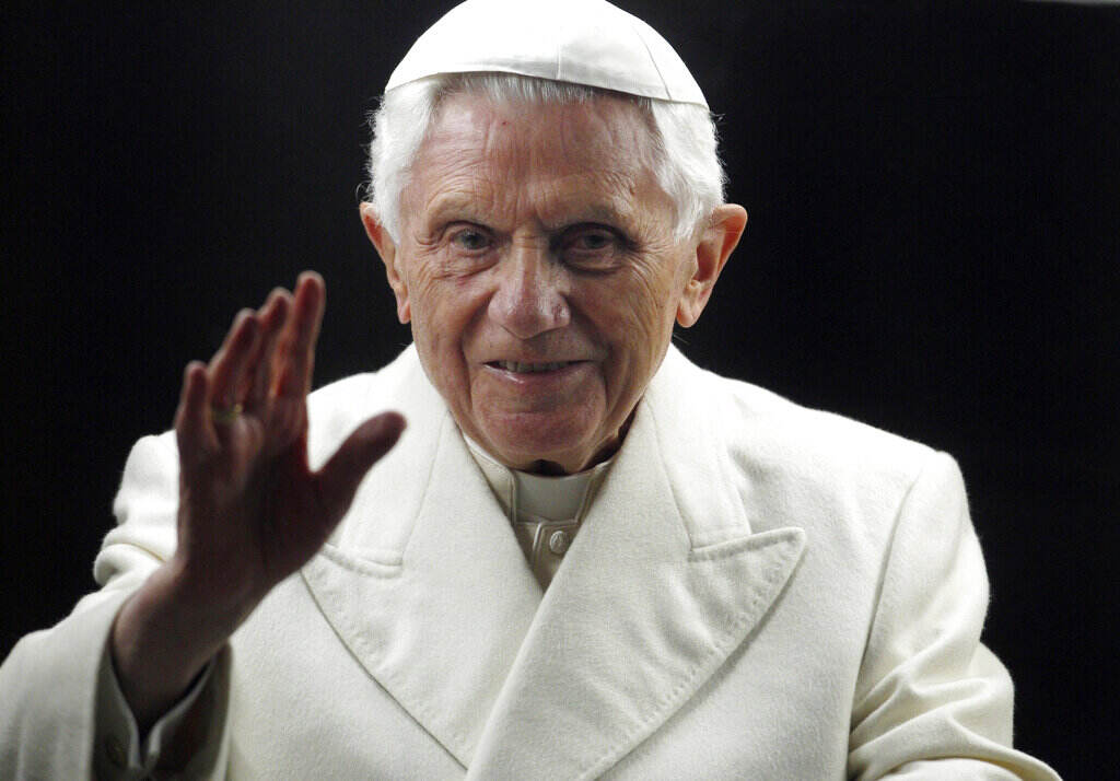 Benedict XVI A man waves his hand.