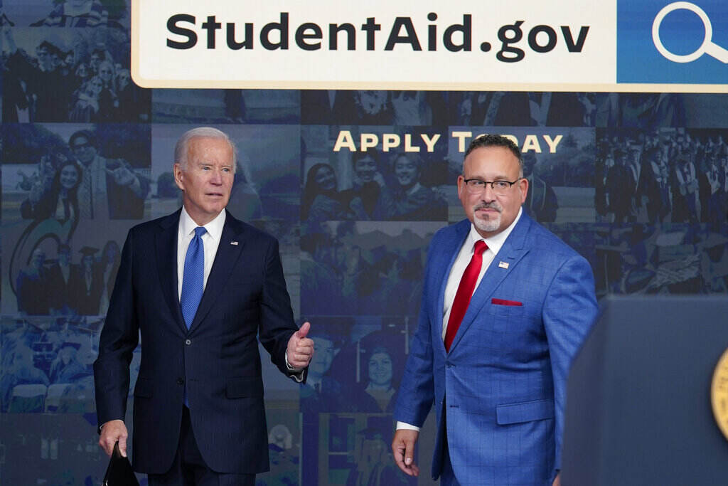 Student Loan Forgiveness President Biden stands with Education Secretary Miguel Cardona