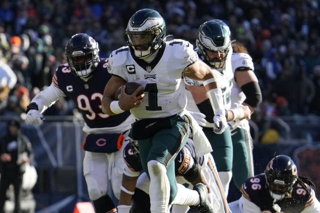 Philadelphia Eagles' Jalen Hurts runs for a touchdown during the first half of an NFL football game against the Chicago Bears, Sunday, Dec. 18, 2022, in Chicago. (AP Photo/Nam Y. Huh)