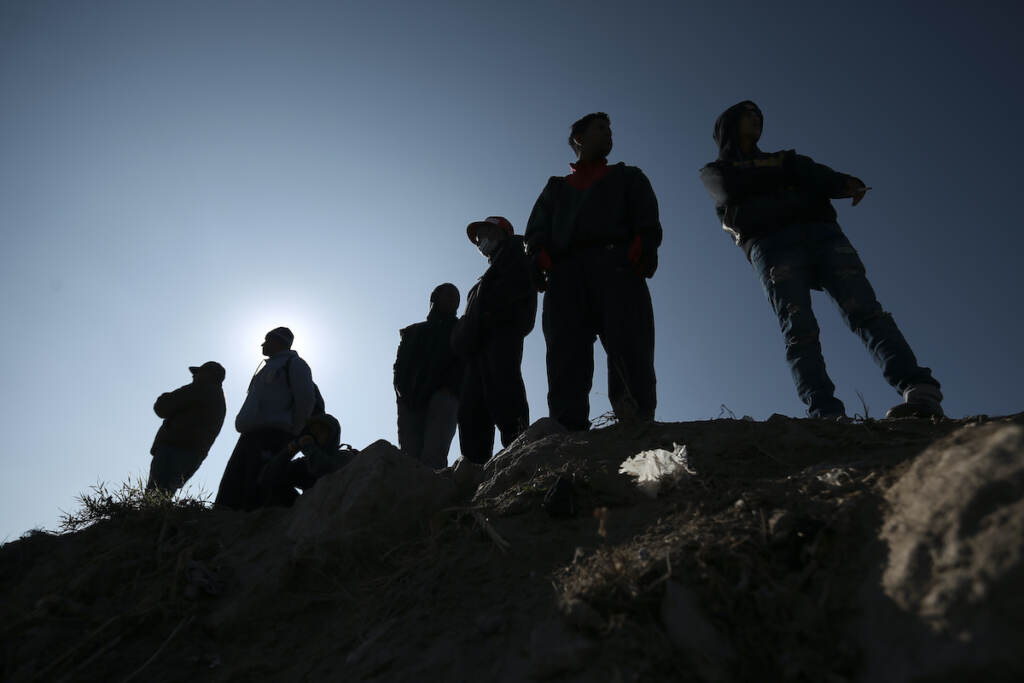 Migrants stand near the U.S.-Mexico border in Ciudad Juarez, Mexico, Monday, Dec. 19, 2022. (AP Photo/Christian Chavez)