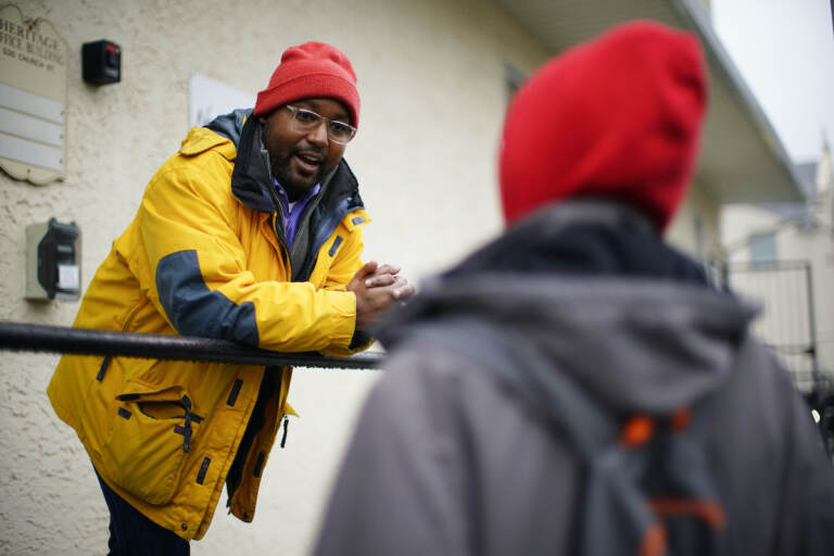 Greg Scott, a newly-elected Democratic member of Pennsylvania's House of Representatives, speaks with a person outside the Hospitality Center which helps people experiencing homelessness and poverty, in Norristown, Pa., Thursday, Dec. 22, 2022. (AP Photo/Matt Rourke)