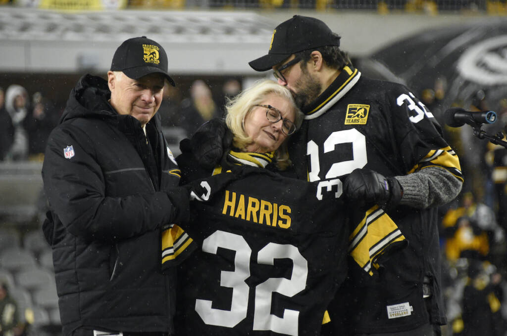 Steelers Harris Football Pittsburgh Steelers owner Art Rooney II, left, and Franco Harris' widow Dana, center, and son Dok, attend a ceremony to retire Harris' No. 32 jersey at half-time of an NFL football game against the Las Vegas Raiders, Saturday, Dec. 24, 2022. Harris, a four-time Super Bowl champion, passed away Dec. 21, 2022, at the age of 72. (AP Photo/Don Wright)
