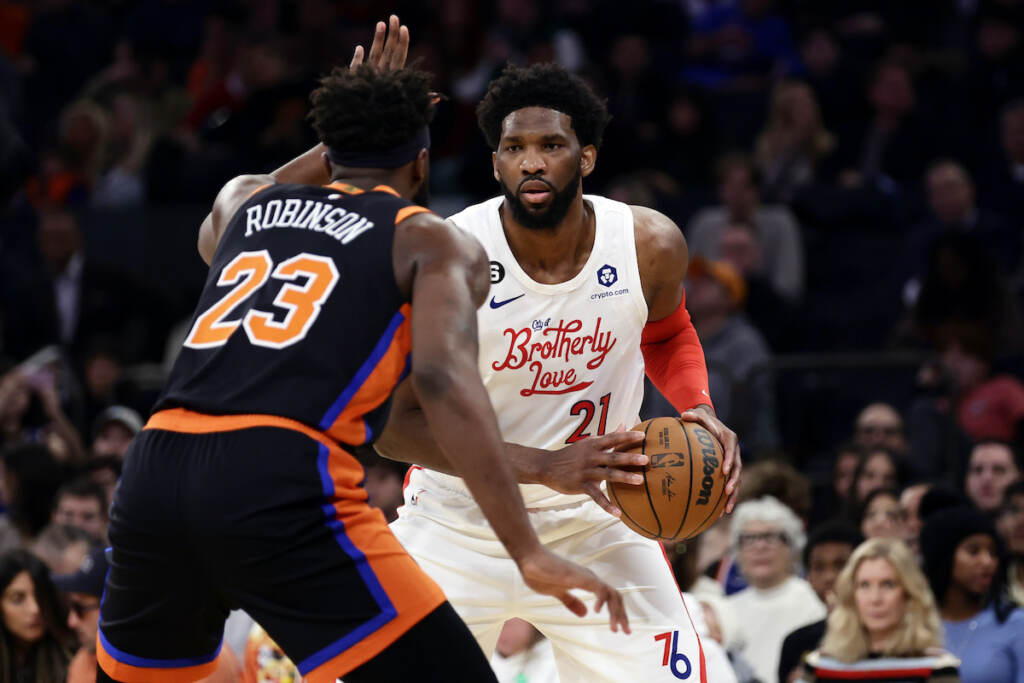 Joel Embiid Philadelphia 76ers center Joel Embiid (21) looks to pass around New York Knicks center Mitchell Robinson during the first half of an NBA basketball game, Sunday, Dec. 25, 2022, in New York. (AP Photo/Adam Hunger)