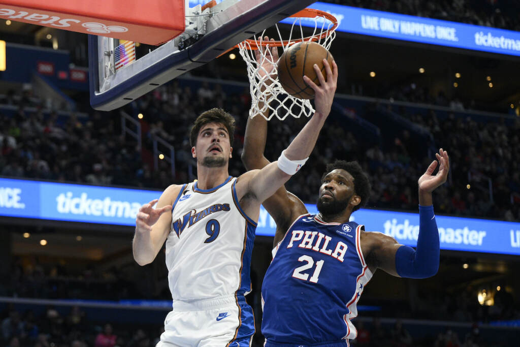76ers Wizards Basketball Washington Wizards forward Deni Avdija (9) goes to the basket against Philadelphia 76ers center Joel Embiid (21) during the first half of an NBA basketball game, Tuesday, Dec. 27, 2022, in Washington. (AP Photo/Nick Wass)