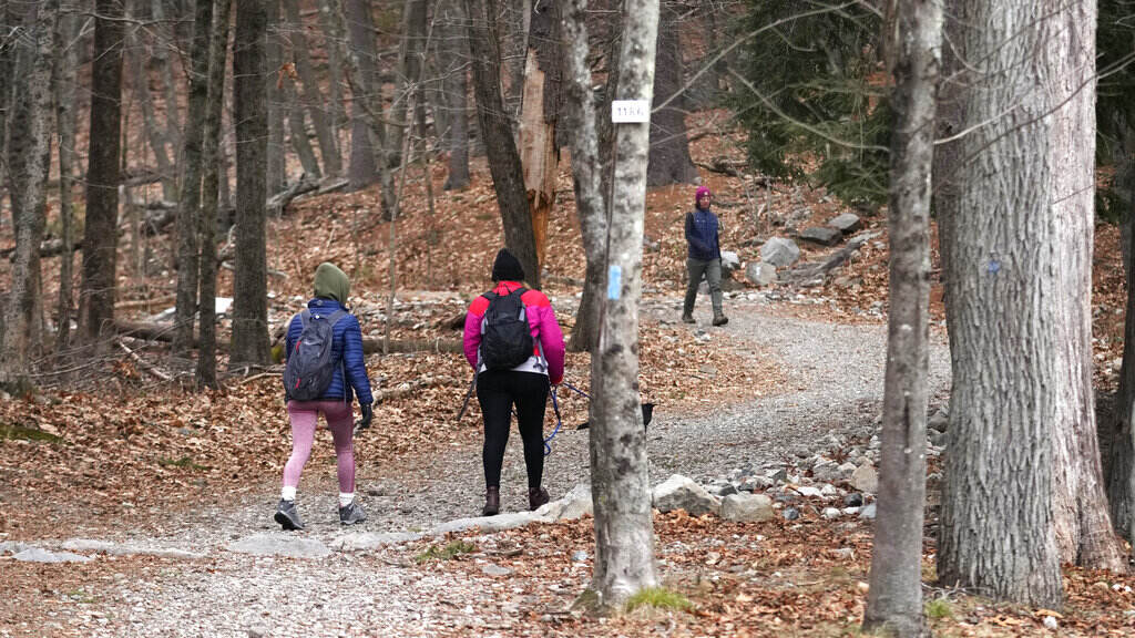 First Day Hikes People walk on a trailhead.
