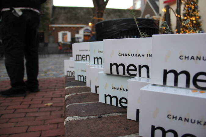 Treats and trinkets were given to those who attended Sunday's Menorah Lighting at the Betsy Ross House on Arch Street. (Cory Sharber/WHYY)