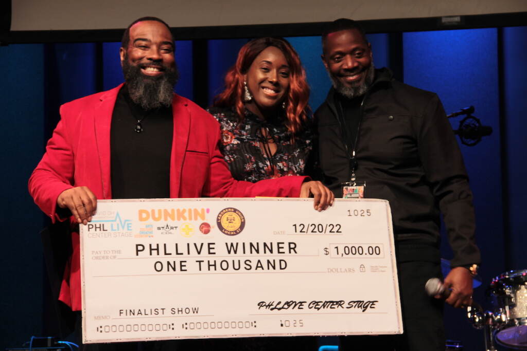 IMG_9544 Gospel winner Frantastic Noise (center) received the check for $1,000 during Tuesday's PHL LIVE Center Stage Award Show. (Cory Sharber/WHYY)