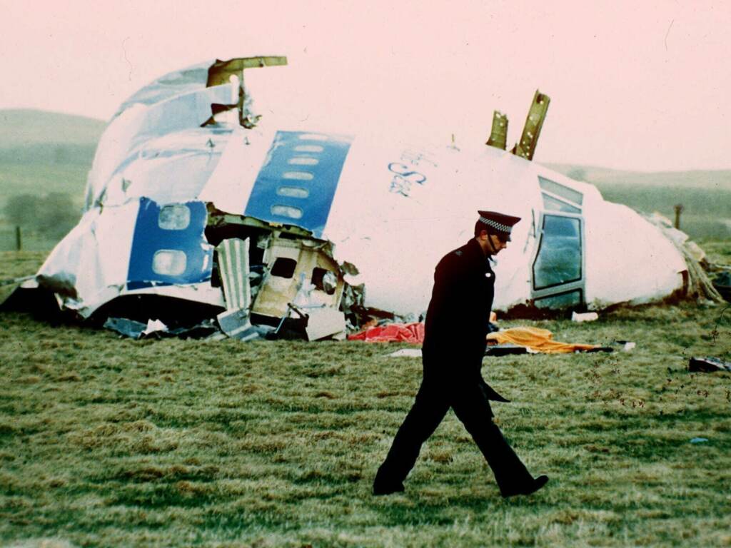 A police officer walks by the nose of Pan Am flight103 in a field near the town of Lockerbie, Scotland in 1988. (Martin Cleaver/AP)
