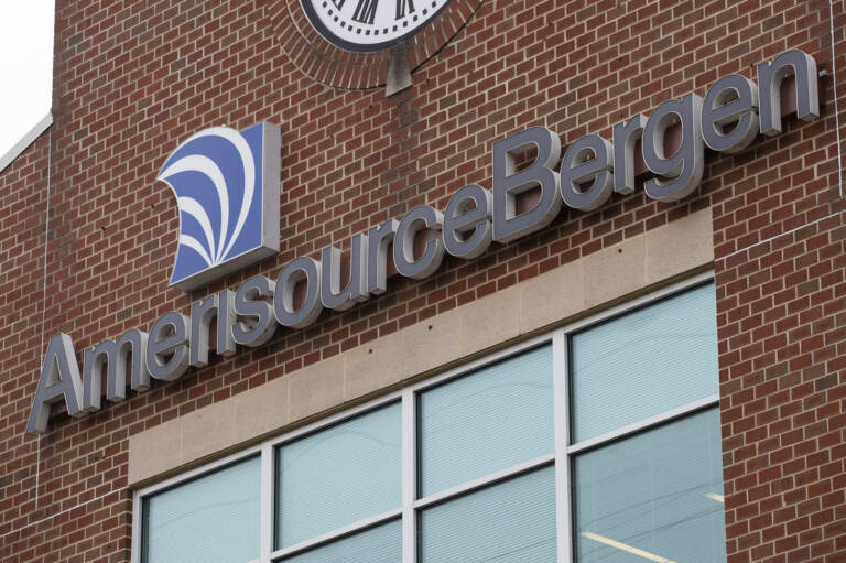 A sign reads AmericsourceBergen on a red-brick building.