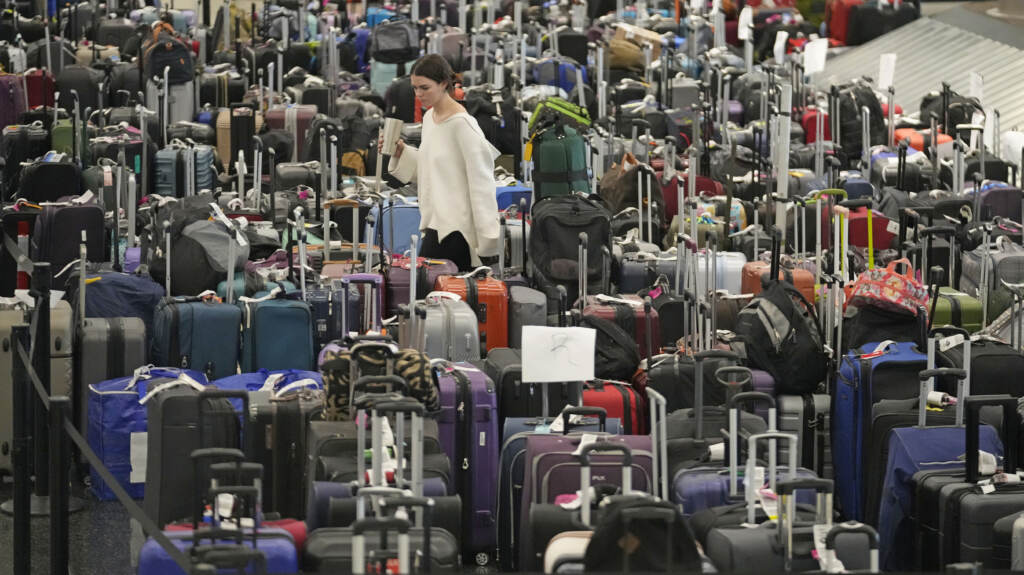 A woman walks through unclaimed bags at Southwest Airlines baggage claim at Salt Lake City International Airport on Thursday, as the carrier canceled another 2,350 flights after a winter storm overwhelmed its operations days ago. A woman walks through unclaimed bags at Southwest Airlines baggage claim at Salt Lake City International Airport on Thursday, as the carrier canceled another 2,350 flights after a winter storm overwhelmed its operations days ago. (Rick Bowmer/AP)