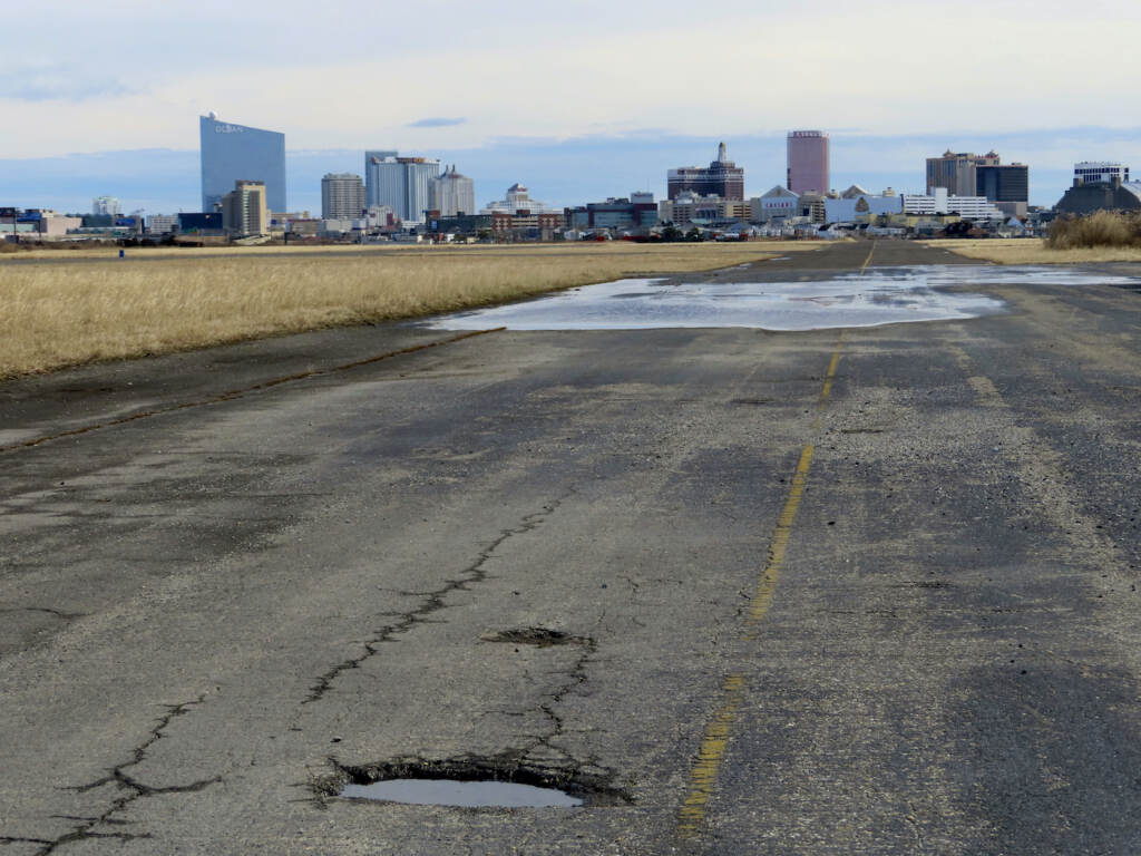 This Feb. 18, 2022 photo shows the potholed runway at the former Bader Field airport site in Atlantic City N.J. On Tuesday, Dec. 21, the City Council had been set to choose a developer for the site, but canceled the vote after a state official asked them to remove the measure from its agenda. (AP Photo/Wayne Parry)