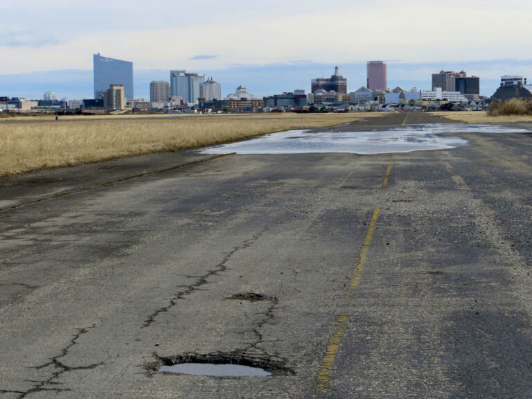 This Feb. 18, 2022 photo shows the potholed runway at the former Bader Field airport site in Atlantic City N.J. On Tuesday, Dec. 21, the City Council had been set to choose a developer for the site, but canceled the vote after a state official asked them to remove the measure from its agenda. (AP Photo/Wayne Parry)