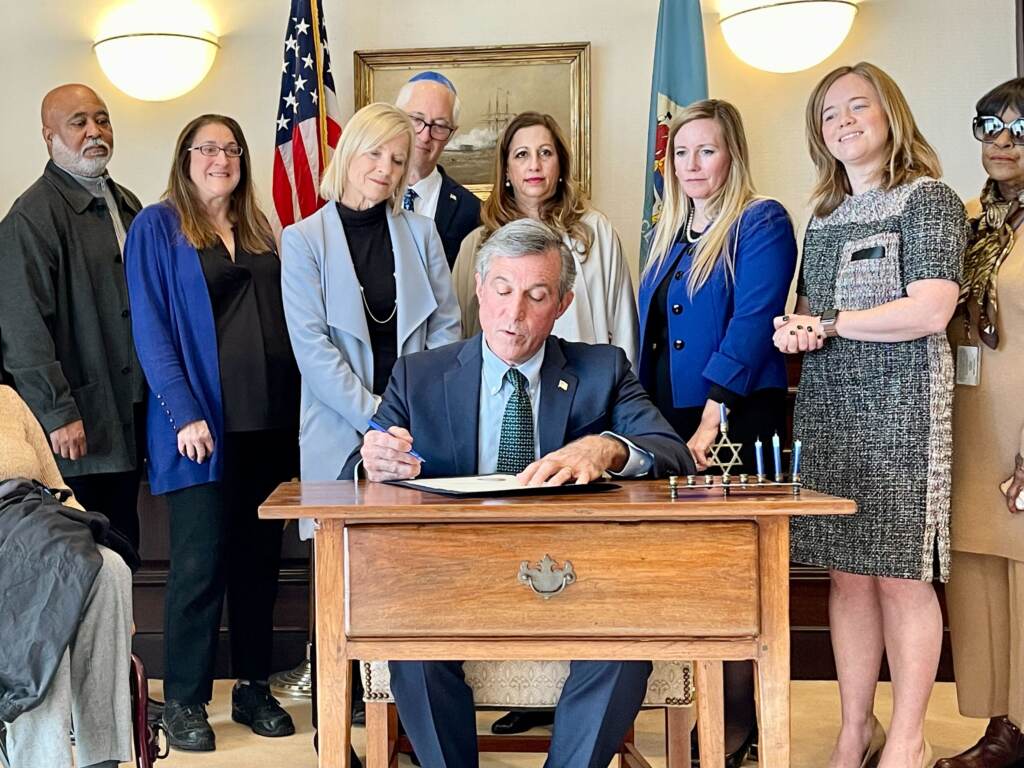 carney-shine-light-j-perez-2022-12-21 Governor John Carney, along with other government leaders and members of the Jewish community, sign the proclamation as part of the 'Shine a Light' campaign. (Johnny Perez-Gonzalez/WHYY)
