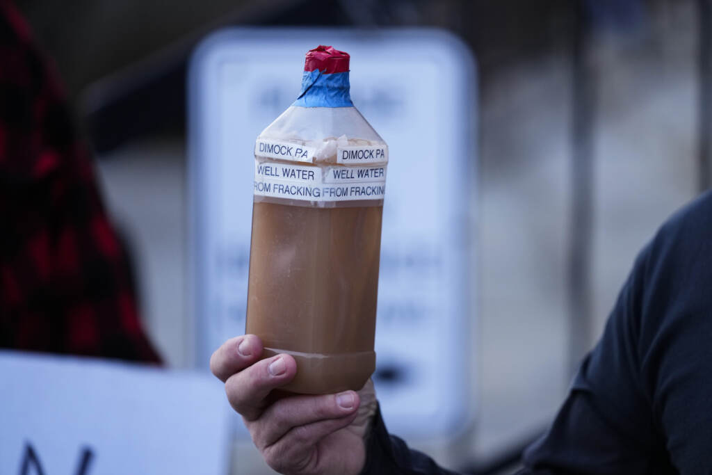 Gas Drilling-Water Pollution Craig Stevens holds a bottle of brown water